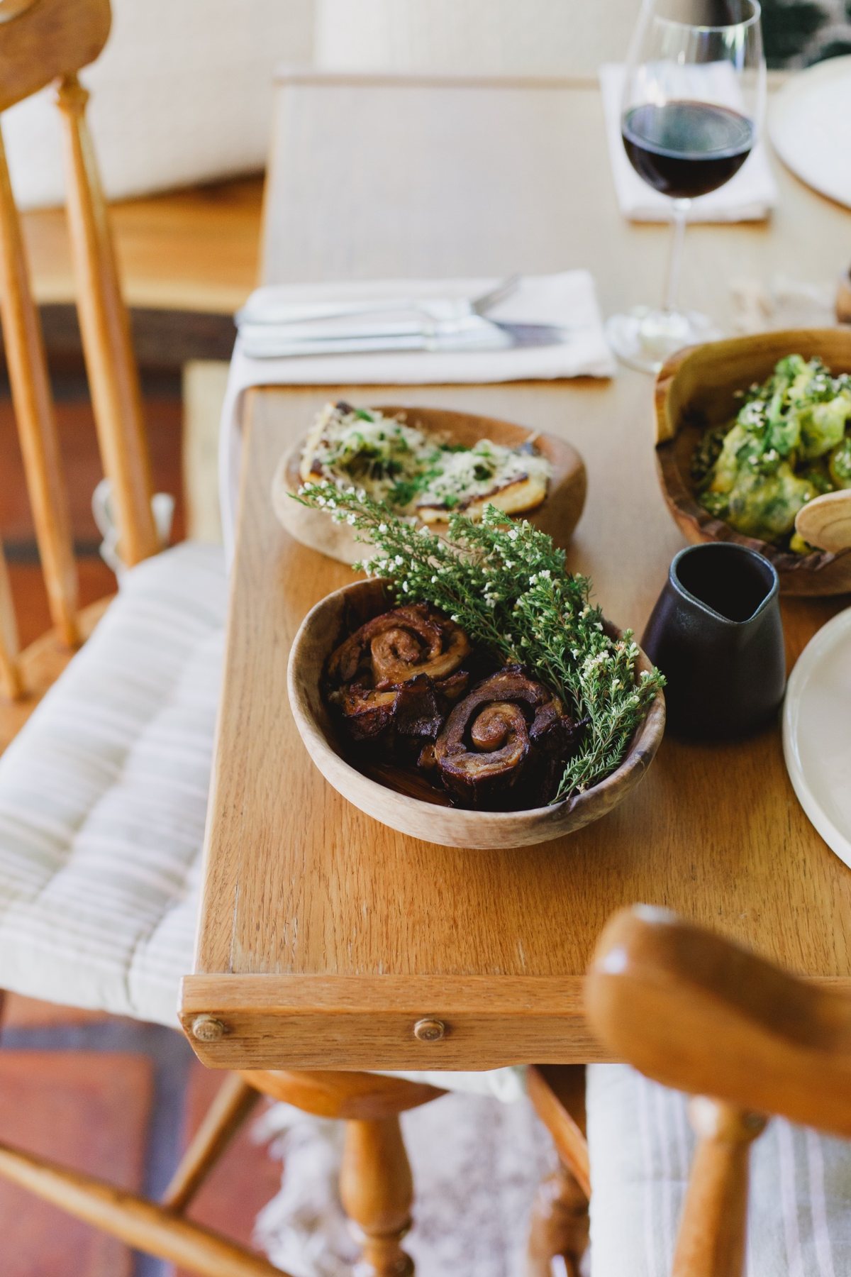 A table of Melfort sharing dishes, vegetables and sauce