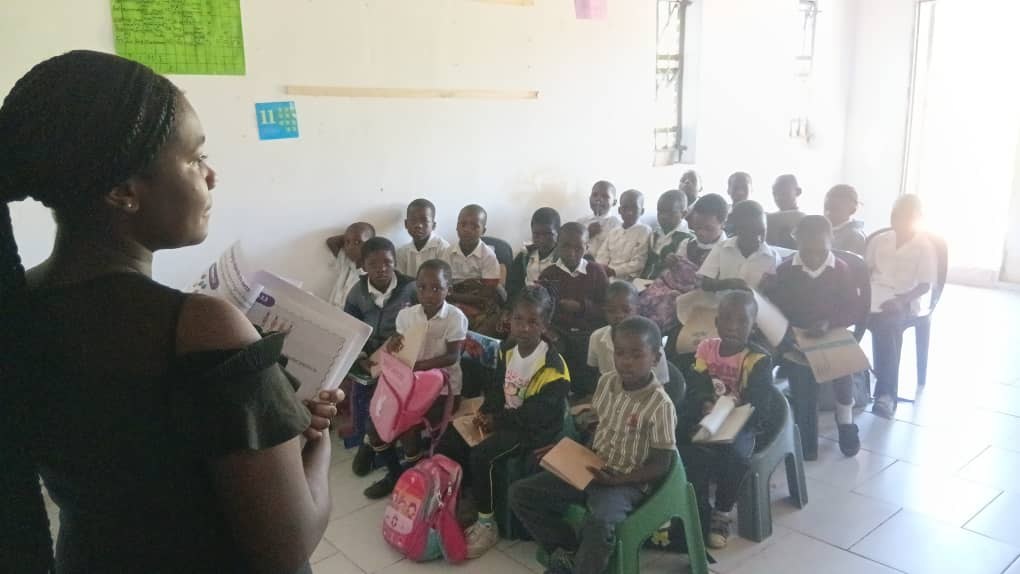 Children and a teacher together in a Rock of Wisdom classroom